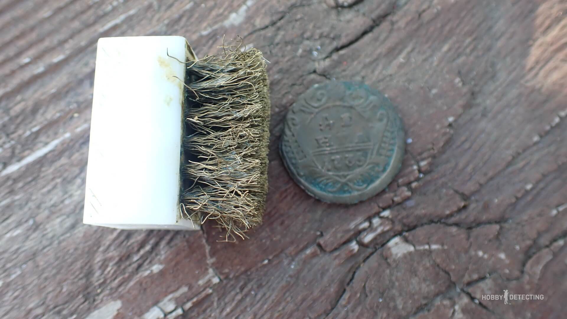 Cleaning copper coins in soapy water