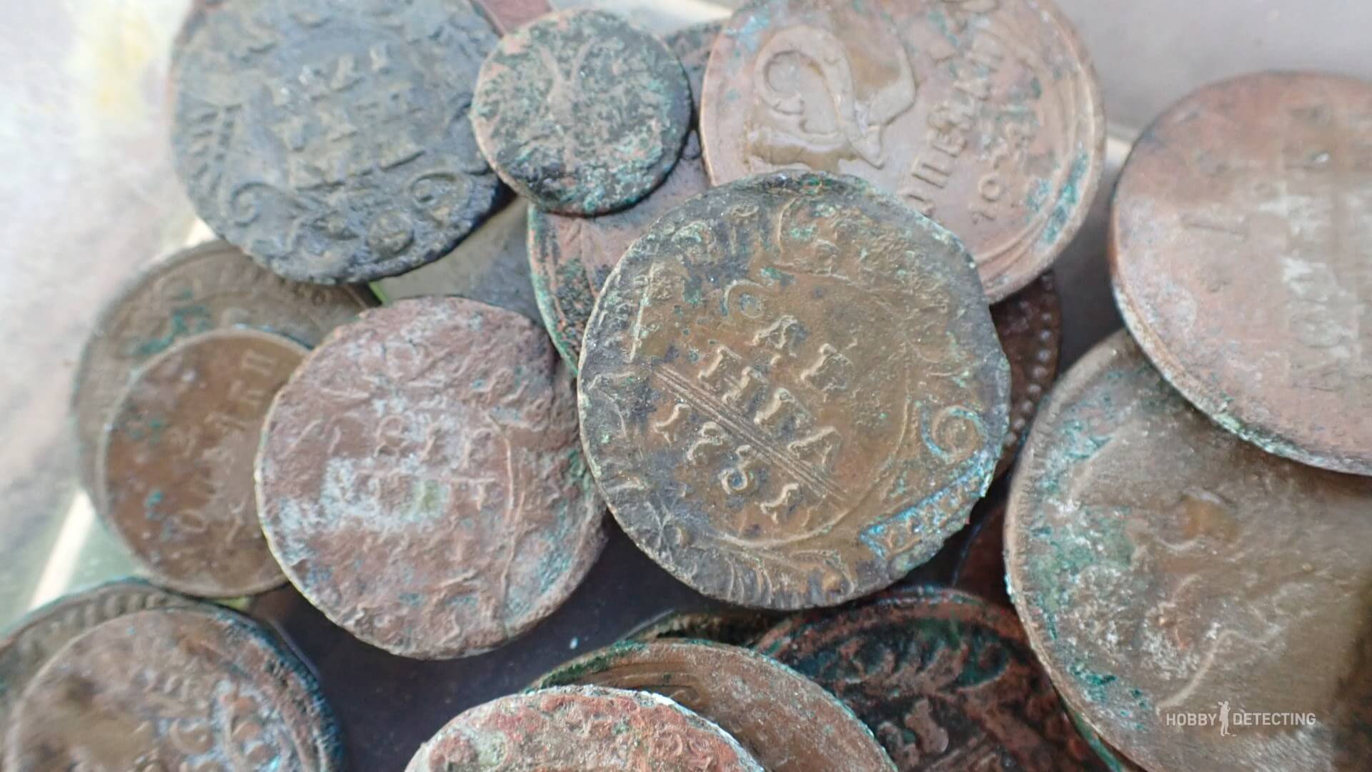 Cleaning copper coins in soapy water